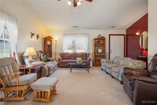 a living room with furniture and a gym