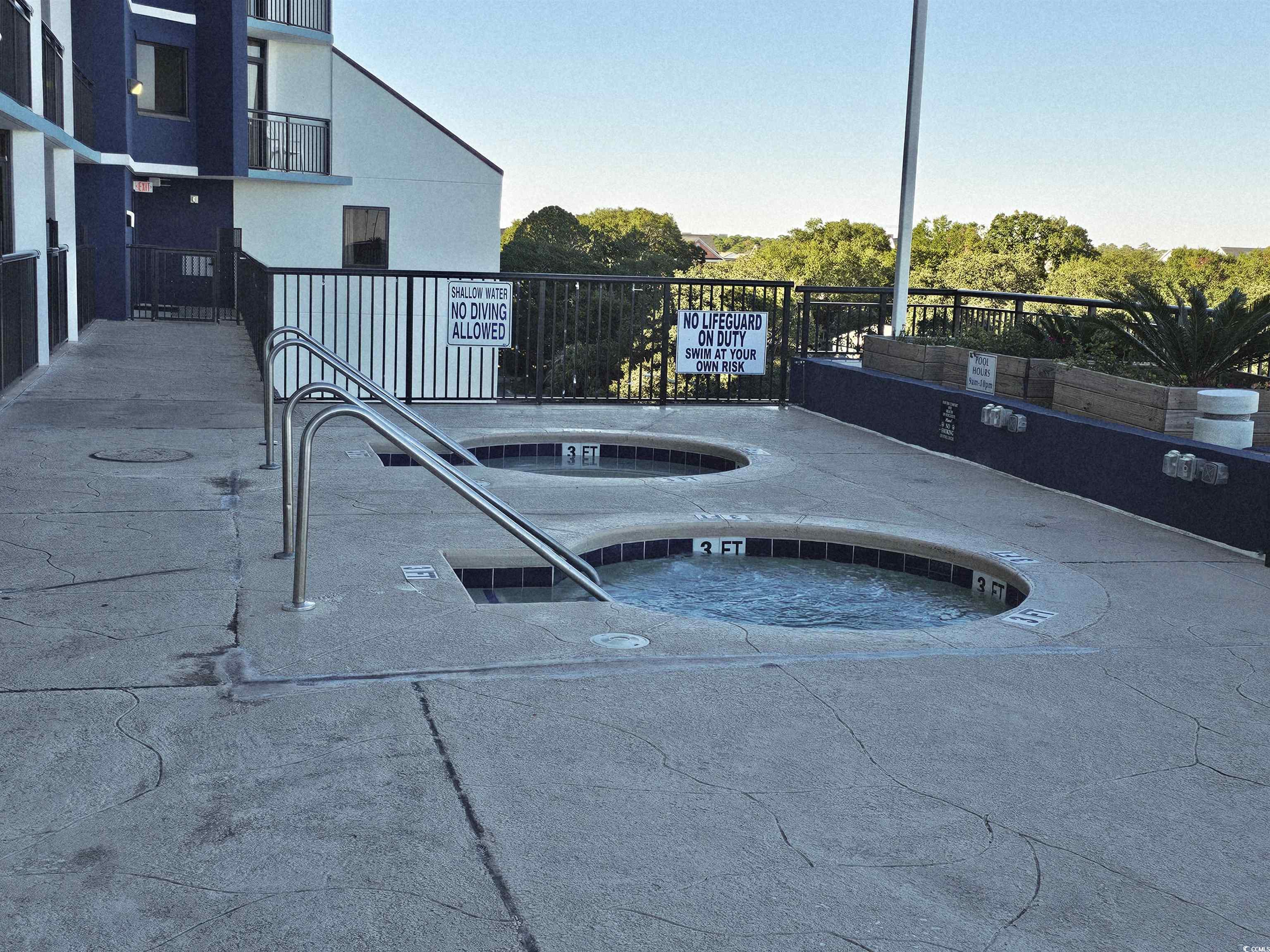 201 77th Avenue North, Unit 1025 Myrtle Beach, SC 29572 - Photo 19 of 36 View of pool featuring a hot tub