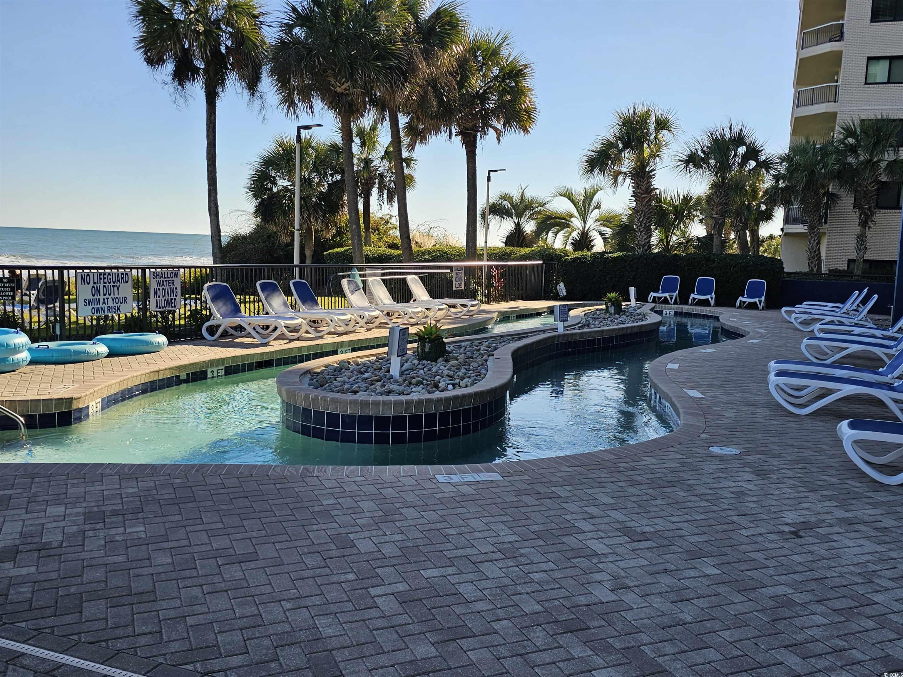 201 77th Avenue North, Unit 1025 Myrtle Beach, SC 29572 - Photo 24 of 36 Community pool with a hot tub and a patio area