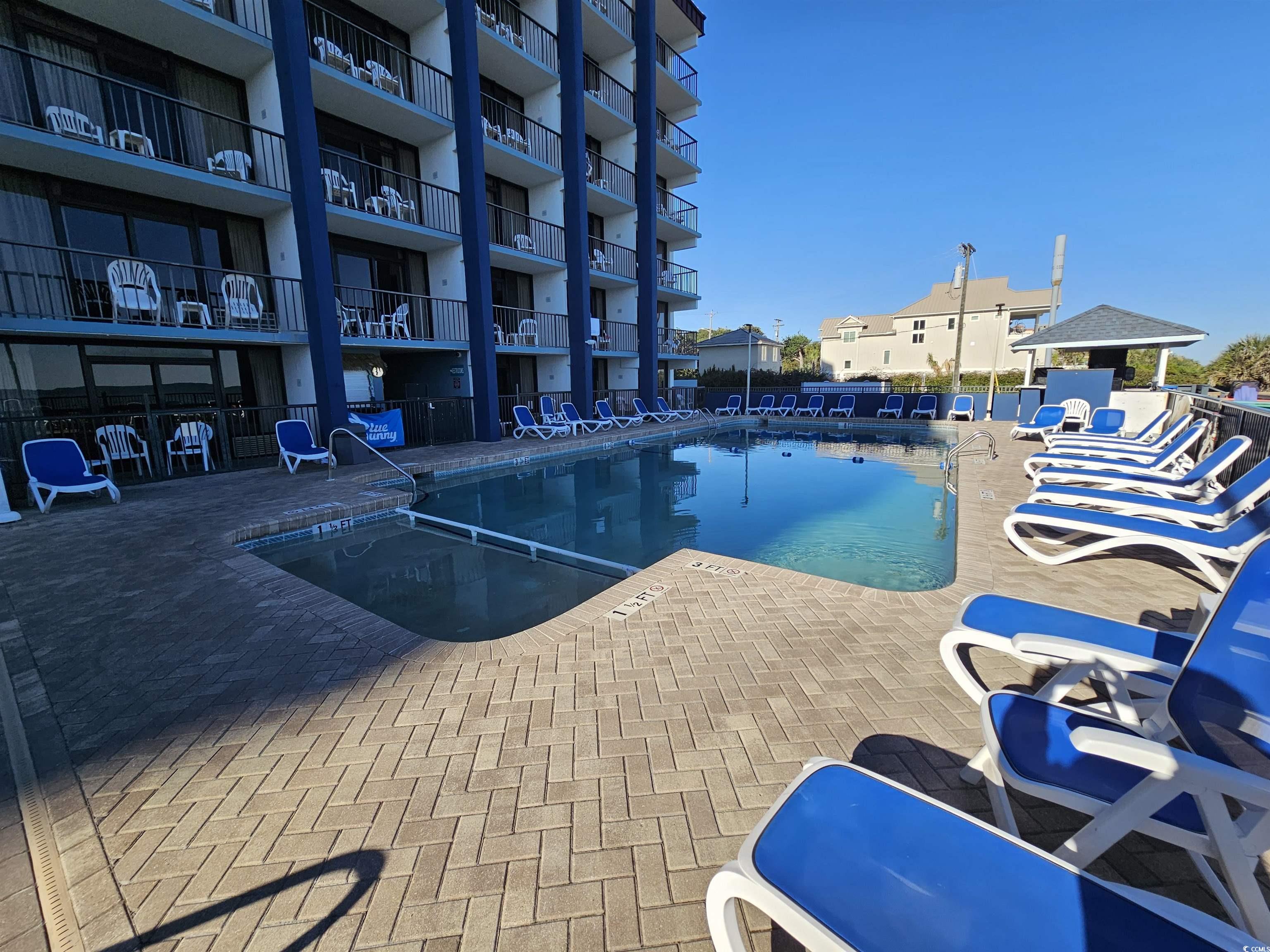 201 77th Avenue North, Unit 1025 Myrtle Beach, SC 29572 - Photo 26 of 36 Community pool featuring a patio