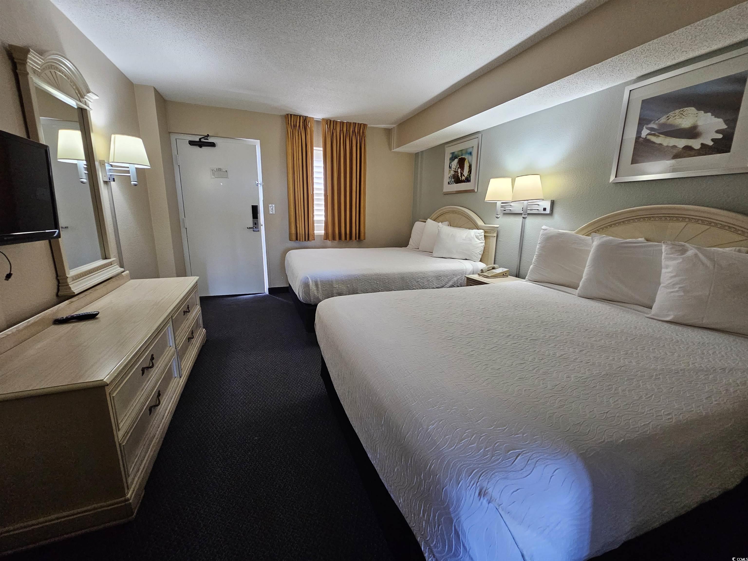 201 77th Avenue North, Unit 1025 Myrtle Beach, SC 29572 - Photo 3 of 36 Bedroom featuring a textured ceiling and dark colored carpet
