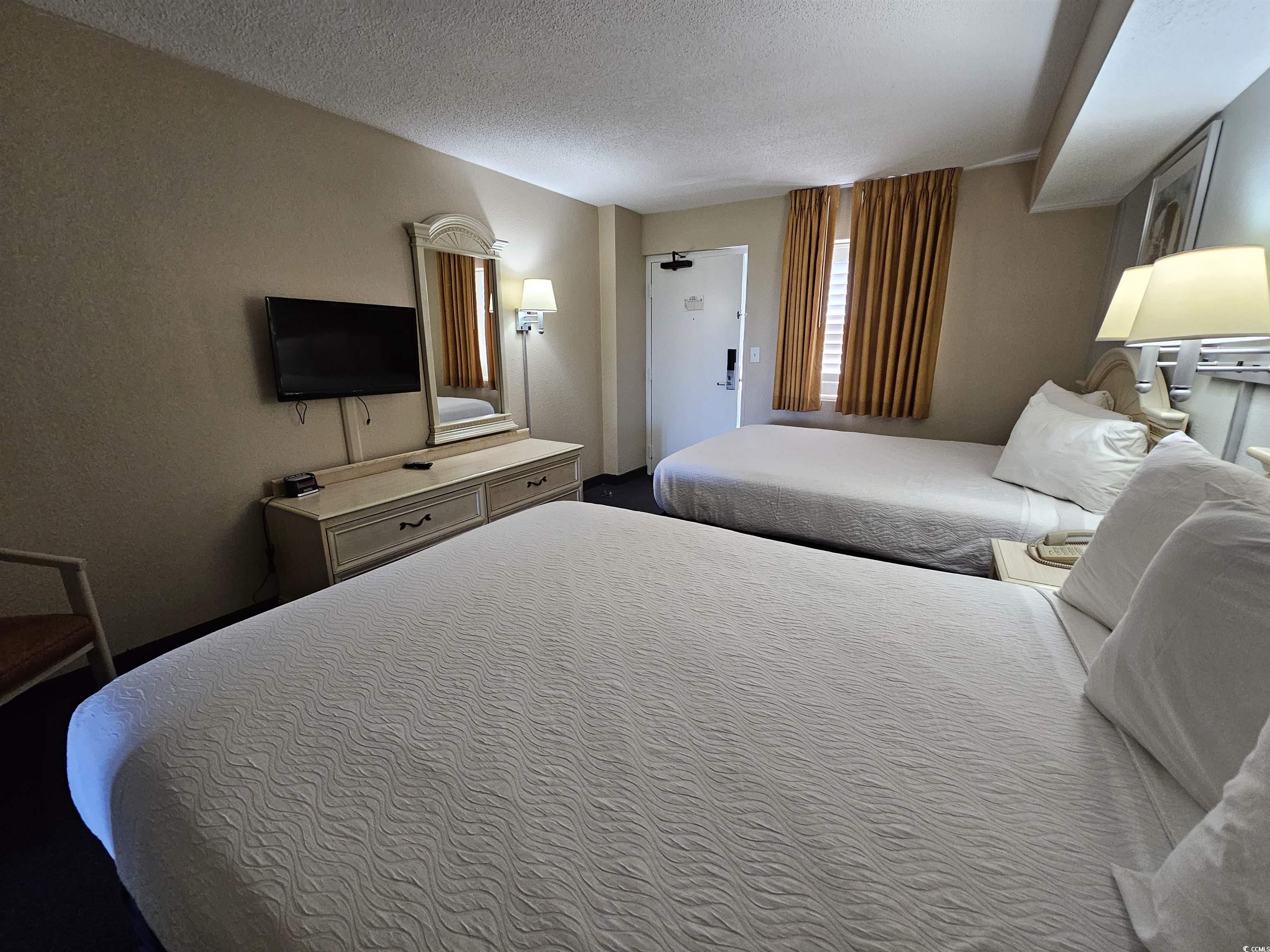 201 77th Avenue North, Unit 1025 Myrtle Beach, SC 29572 - Photo 4 of 36 Bedroom featuring a textured ceiling and a textured wall