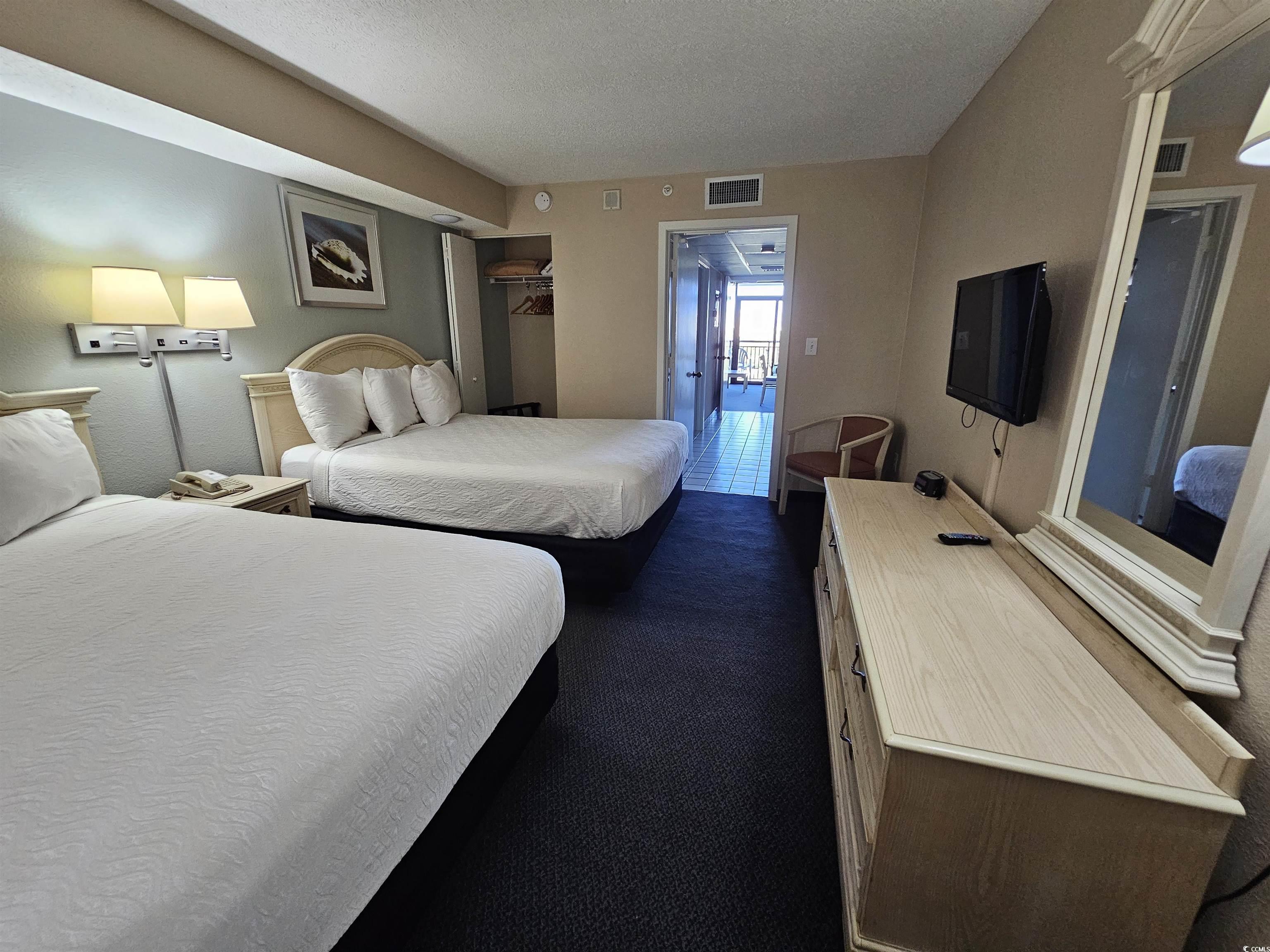 201 77th Avenue North, Unit 1025 Myrtle Beach, SC 29572 - Photo 6 of 36 Bedroom featuring dark colored carpet and a textured ceiling