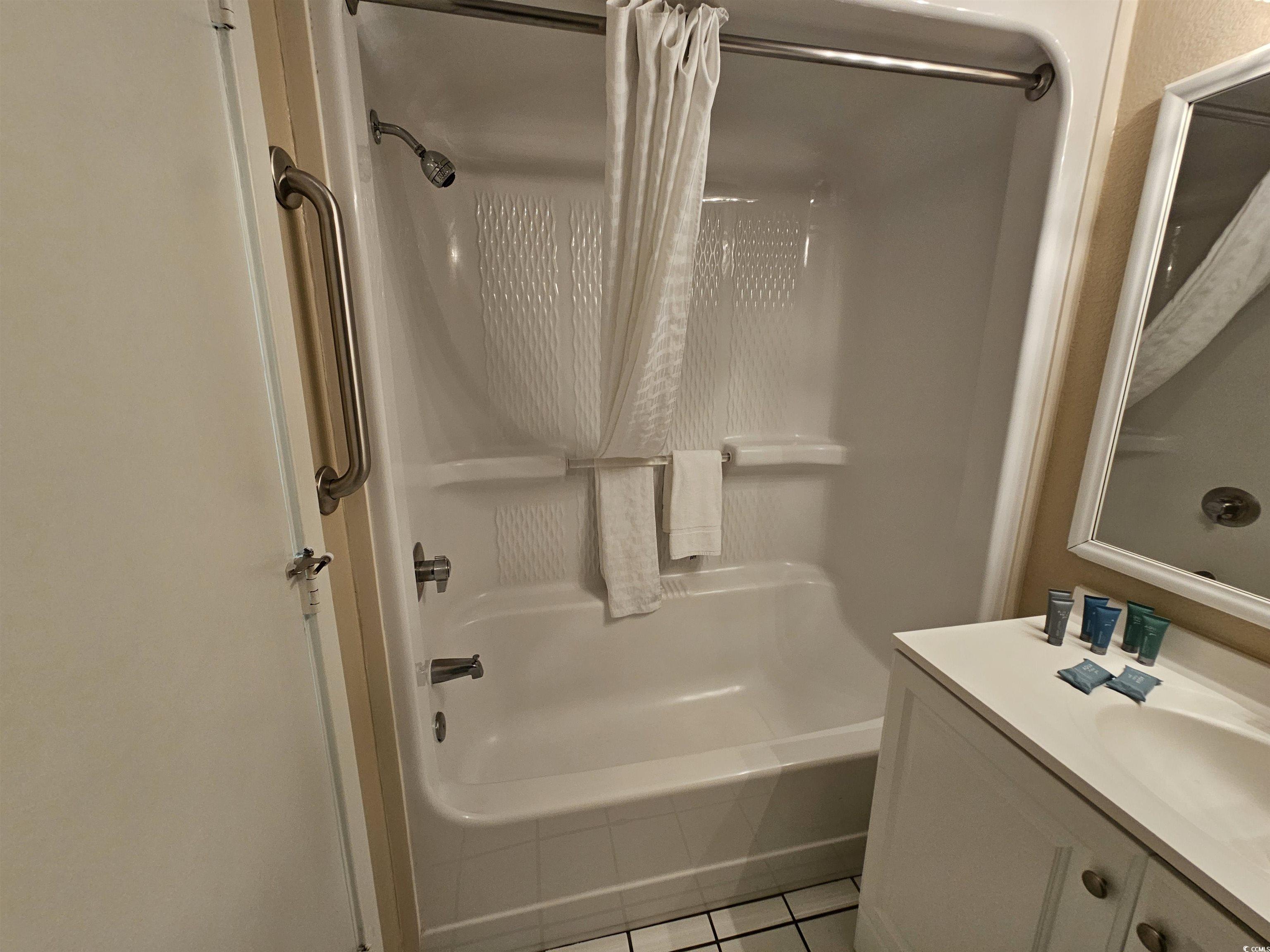 201 77th Avenue North, Unit 1025 Myrtle Beach, SC 29572 - Photo 8 of 36 Full bath with shower / bath combination with curtain, vanity, and light tile patterned floors