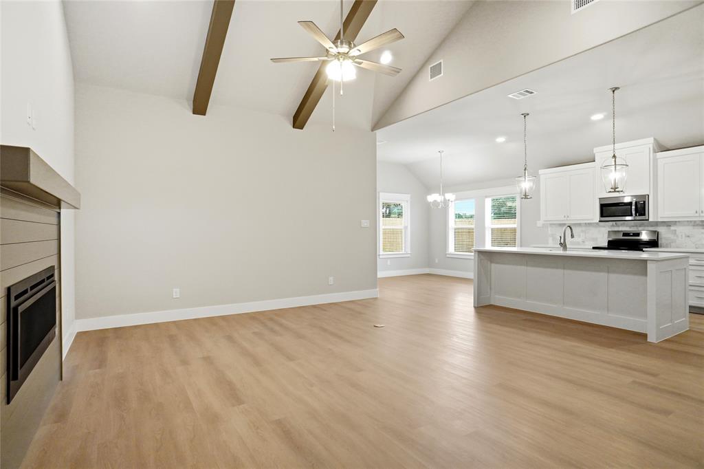 133 Joel Street Springtown, TX 76082 - Photo 2 of 15 a view of a kitchen with a sink and a stove top oven