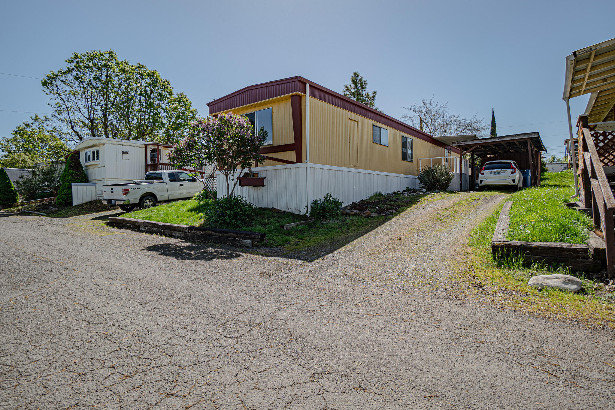421 Stevens Road, Unit 26 Eagle Point, OR 97524 - Photo 21 of 23 a front view of a house with a yard and garage