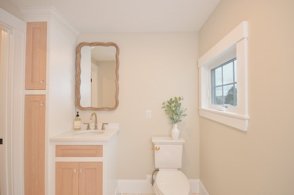 52 Uncle Barneys Road Dennis, MA 02670 - Photo 17 of 42 a bathroom with a toilet sink and mirror