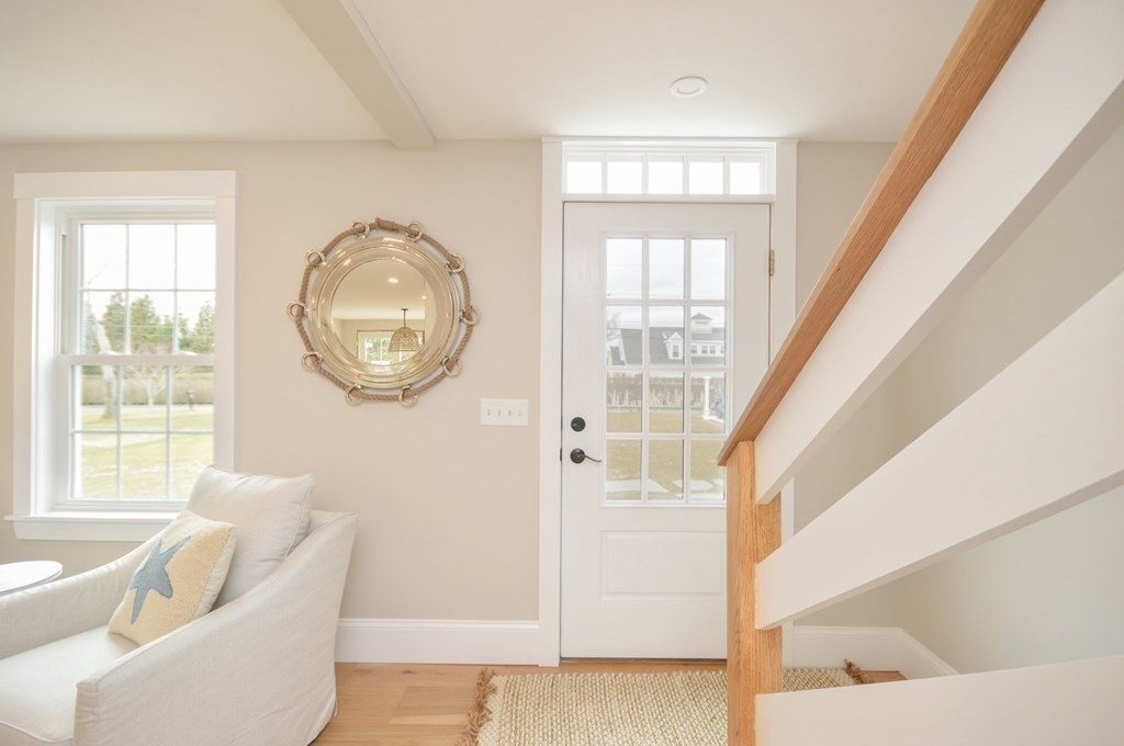 52 Uncle Barneys Road Dennis, MA 02670 - Photo 19 of 42 a living room with furniture and a large window