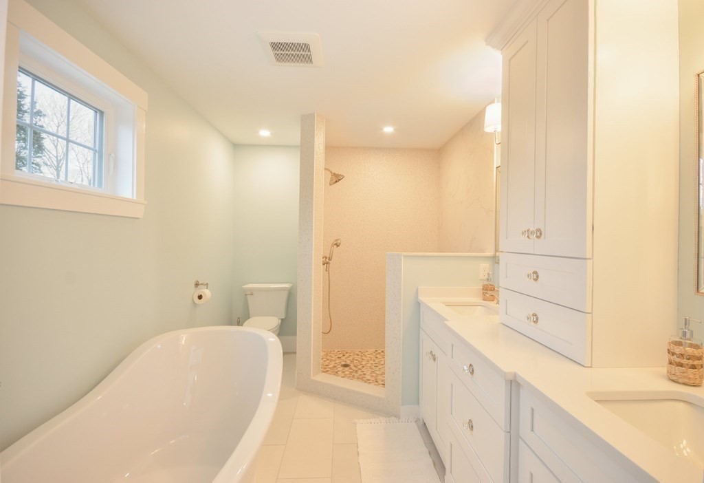 52 Uncle Barneys Road Dennis, MA 02670 - Photo 24 of 42 a spacious bathroom with a tub sink and mirror