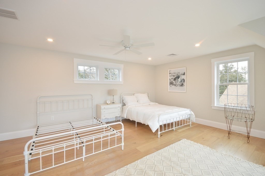 52 Uncle Barneys Road Dennis, MA 02670 - Photo 26 of 42 a spacious bedroom with a bed and a window