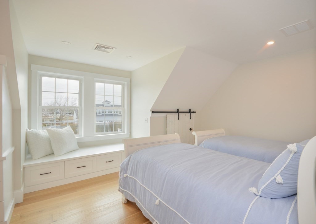 52 Uncle Barneys Road Dennis, MA 02670 - Photo 29 of 42 a bedroom with a bed and a large window