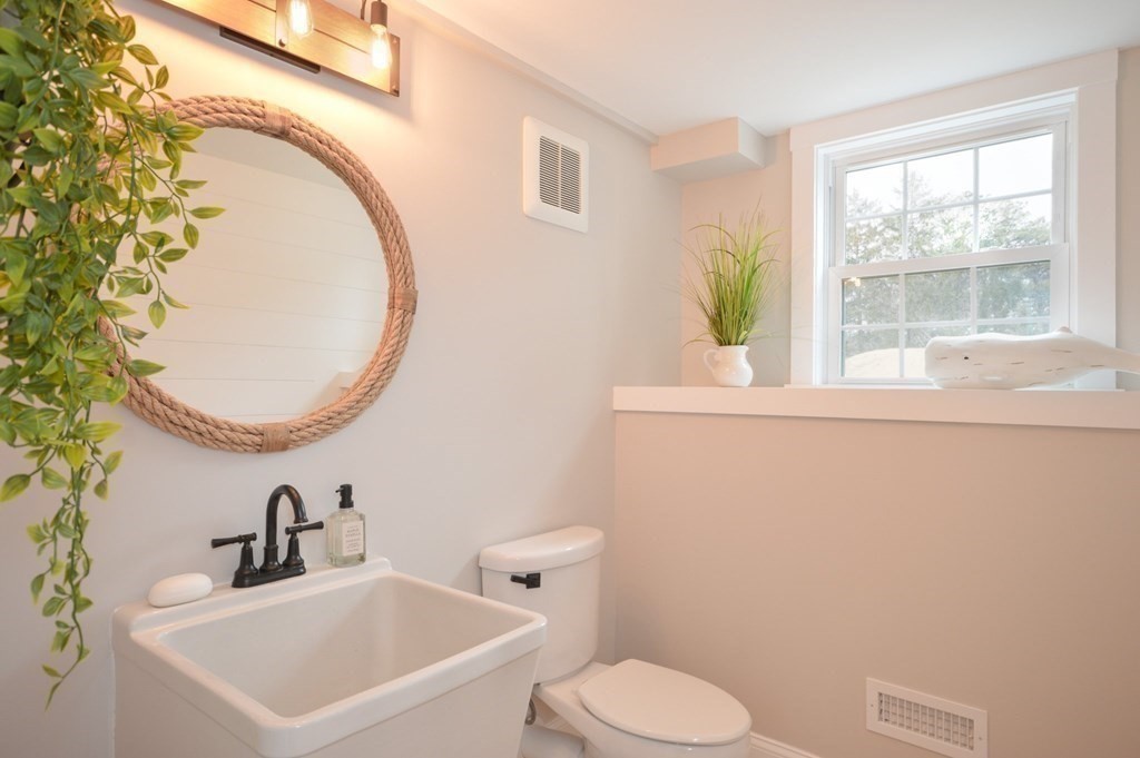 52 Uncle Barneys Road Dennis, MA 02670 - Photo 34 of 42 a bathroom with a sink mirror and toilet