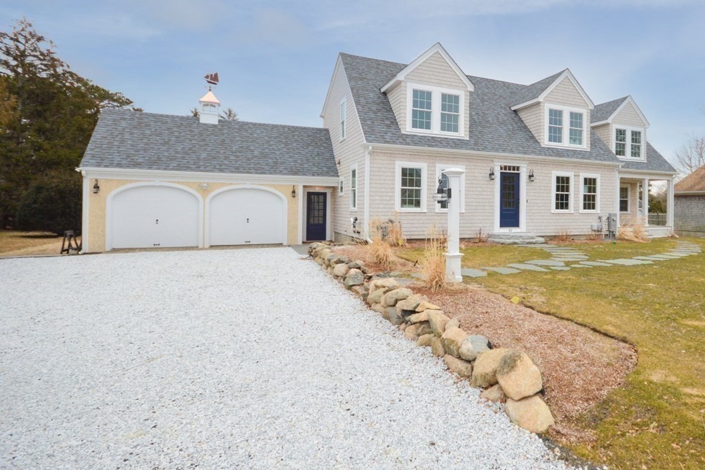 52 Uncle Barneys Road Dennis, MA 02670 - Photo 35 of 42 a front view of a house with a yard