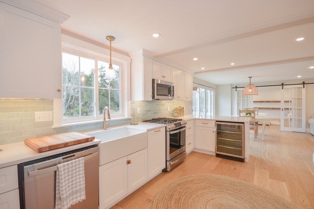 52 Uncle Barneys Road Dennis, MA 02670 - Photo 4 of 42 a kitchen with a sink stove and cabinets