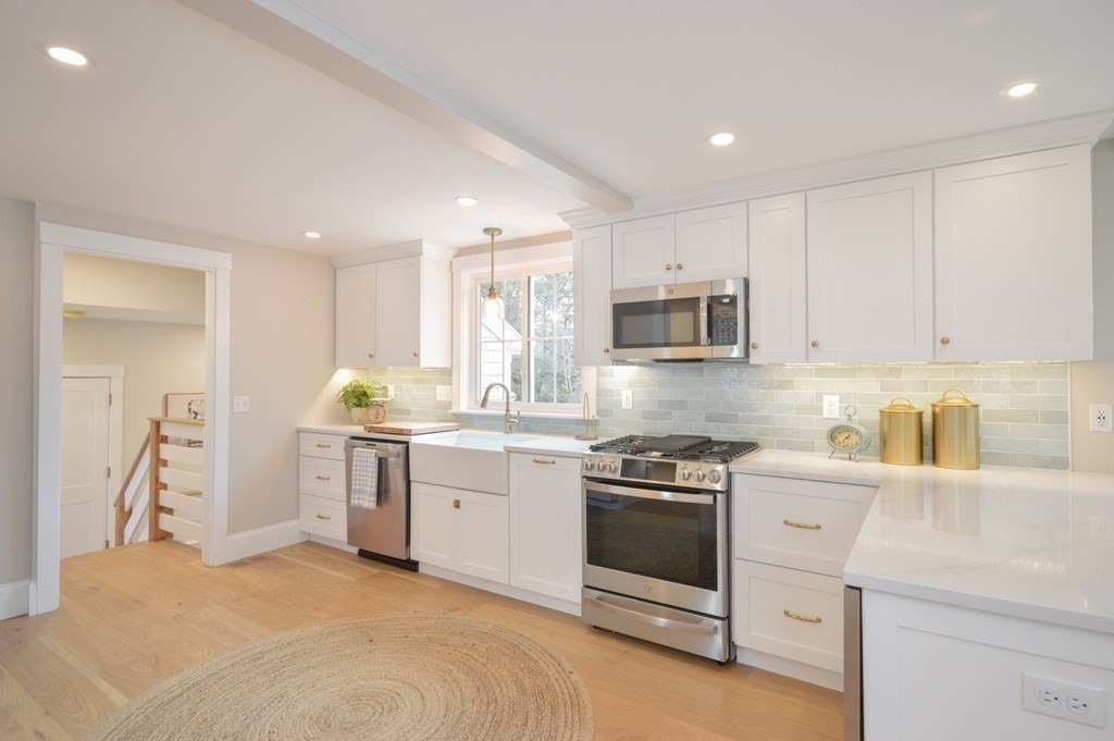 52 Uncle Barneys Road Dennis, MA 02670 - Photo 5 of 42 a kitchen with a sink stove and refrigerator