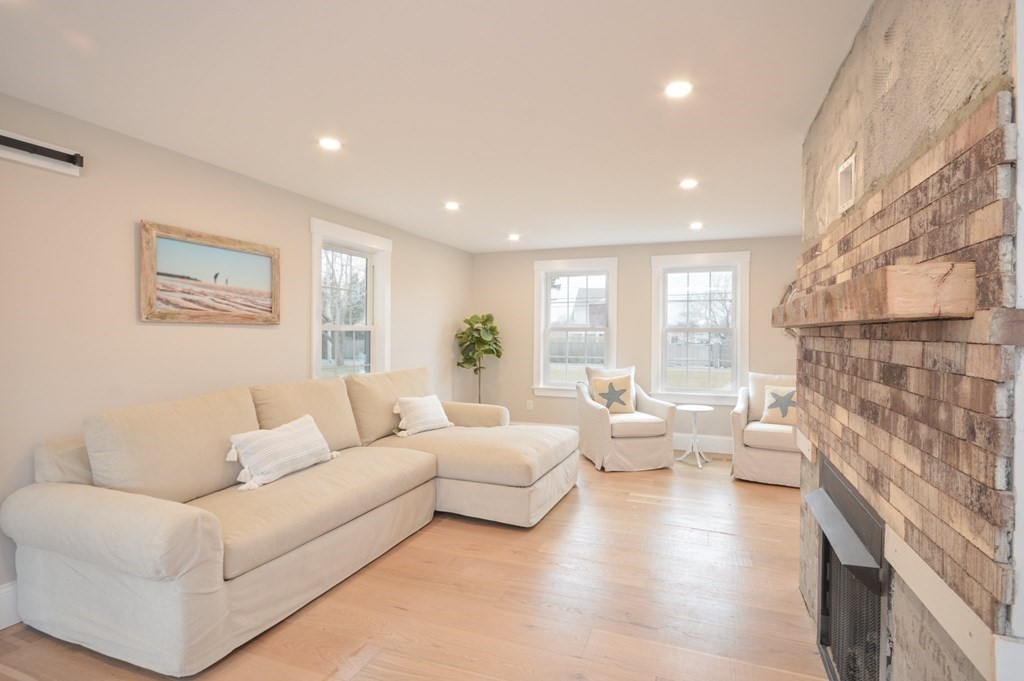 52 Uncle Barneys Road Dennis, MA 02670 - Photo 7 of 42 a living room with fireplace furniture and a couch