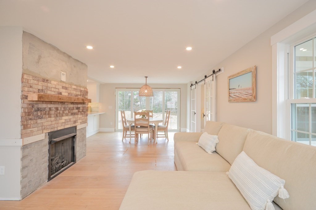 52 Uncle Barneys Road Dennis, MA 02670 - Photo 9 of 42 a living room with furniture and a fireplace
