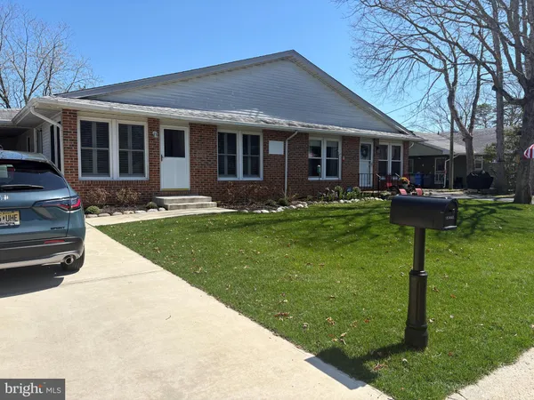 a front view of a house with a yard and porch