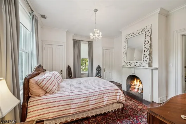 a bedroom with a bed and a chandelier