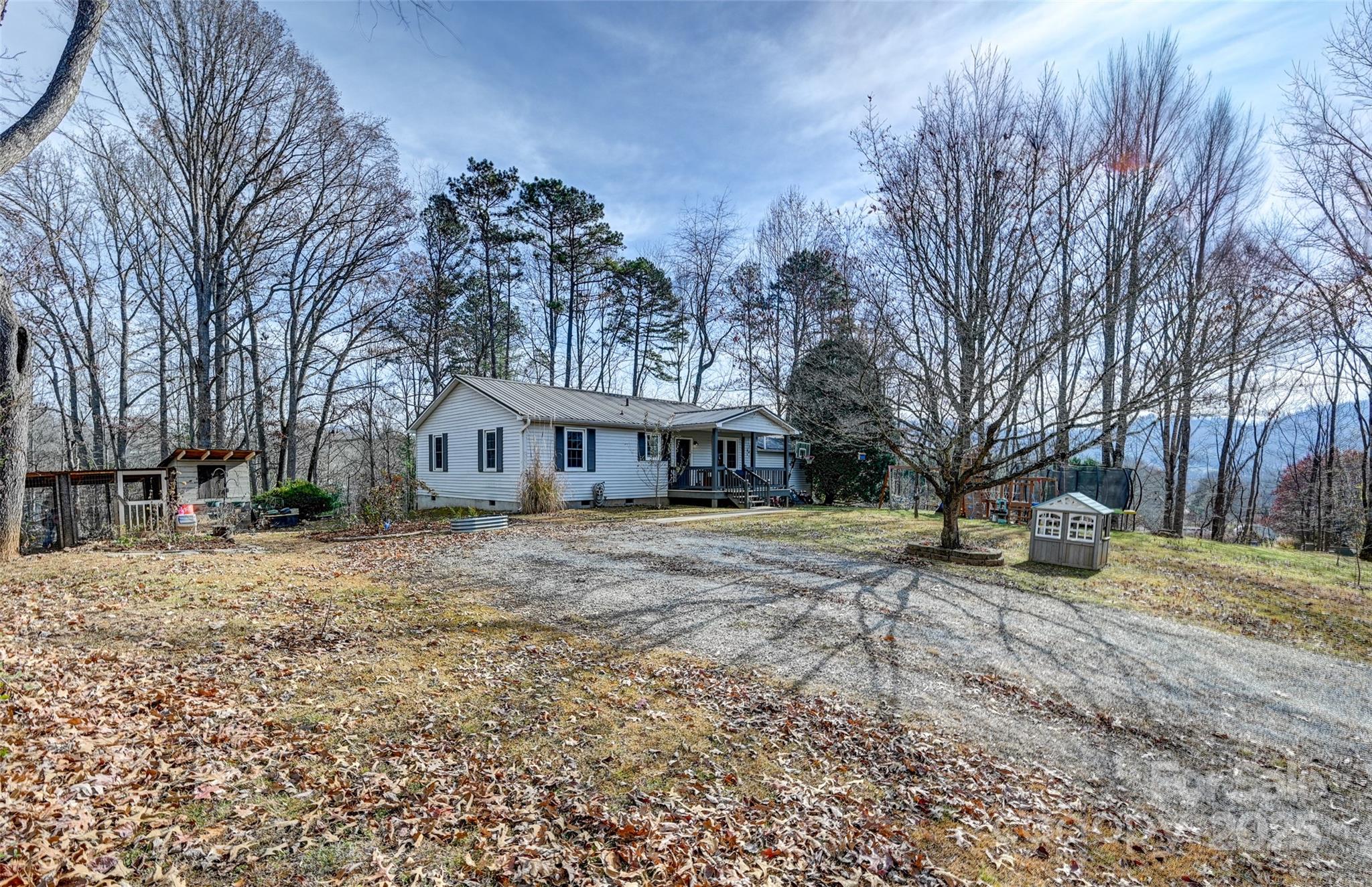 a view of a house with a yard covered in snow