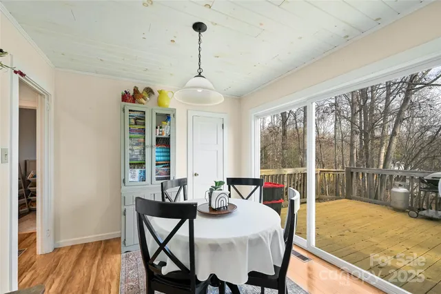 a dining room with furniture a chandelier and wooden floor