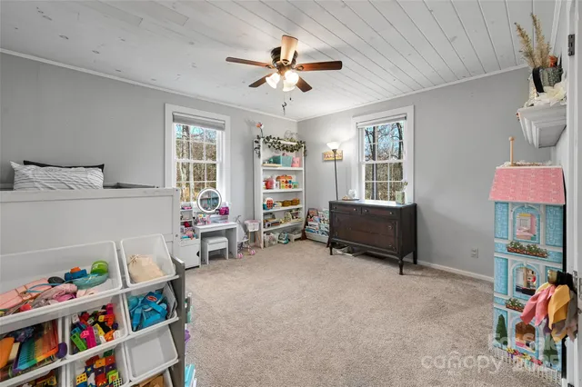 a living room with furniture and a book shelf