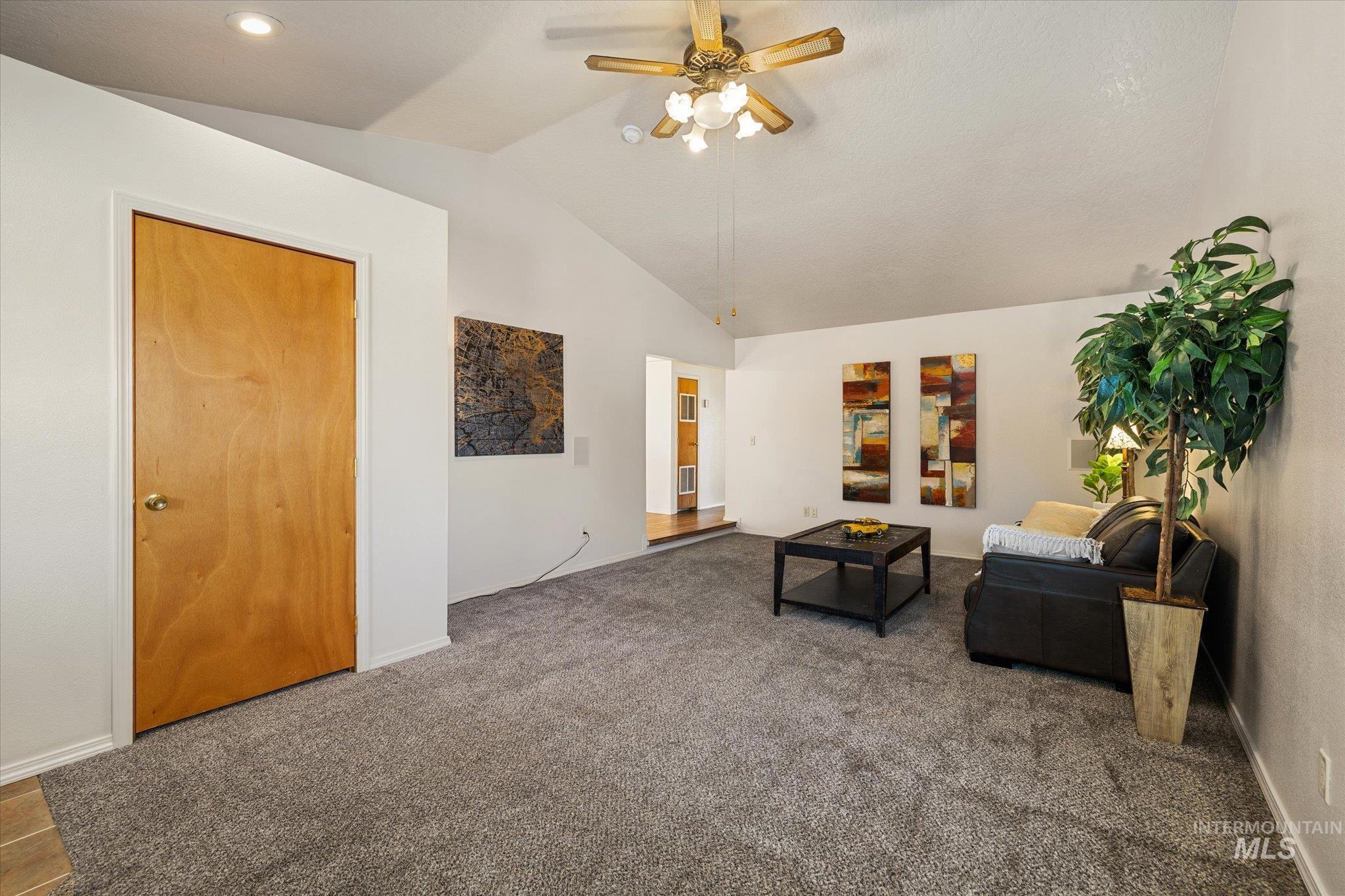 9820 Highway 44 Middleton, ID 83644 - Photo 14 of 50 Carpeted living area with a ceiling fan and lofted ceiling