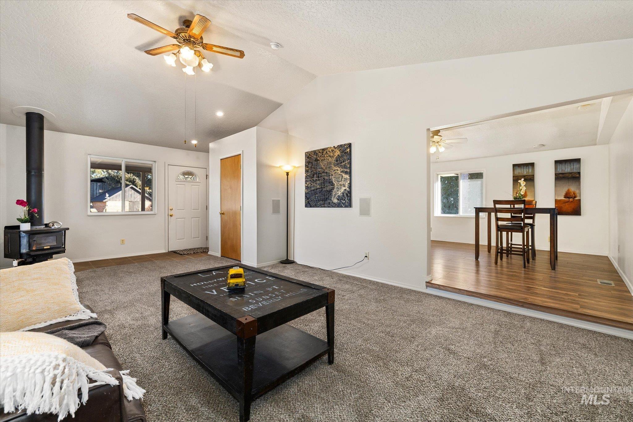 9820 Highway 44 Middleton, ID 83644 - Photo 15 of 50 Carpeted living area with ceiling fan and a wood stove