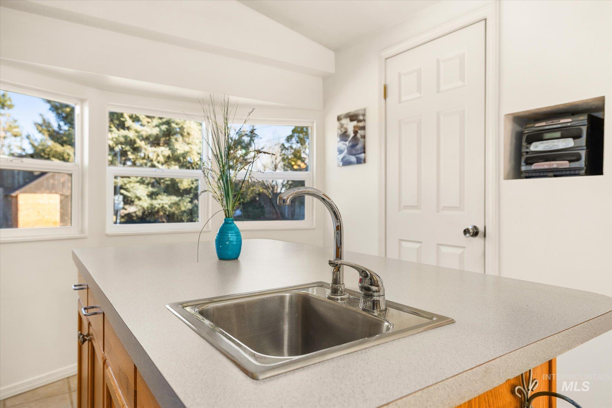 9820 Highway 44 Middleton, ID 83644 - Photo 25 of 50 Kitchen with wood finish cabinetry, vaulted ceiling, and light countertops