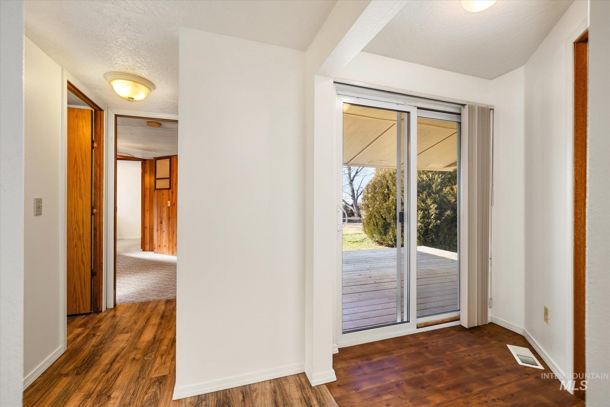 9820 Highway 44 Middleton, ID 83644 - Photo 28 of 50 Doorway with wood finished floors and a textured ceiling