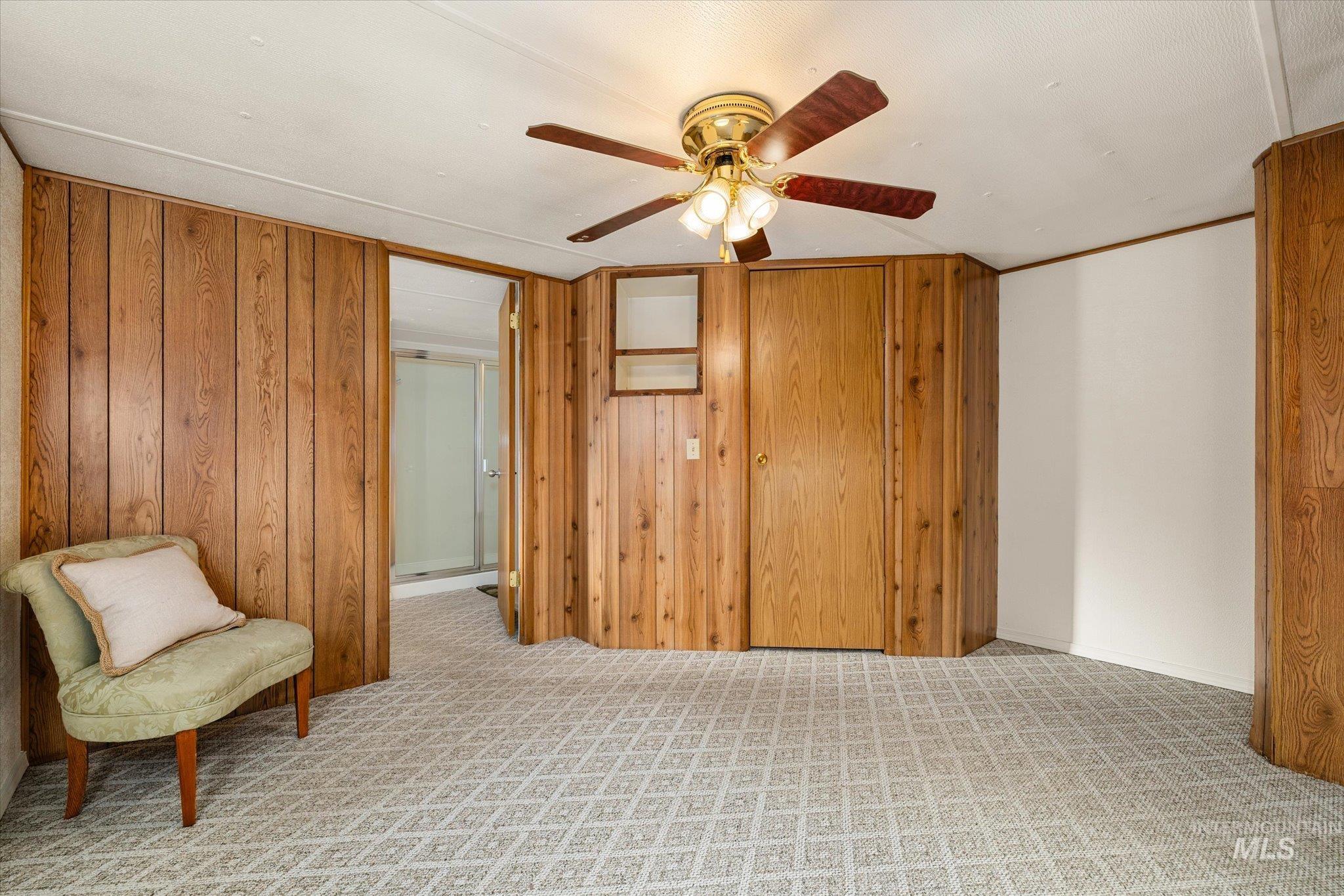 9820 Highway 44 Middleton, ID 83644 - Photo 37 of 50 Sitting room featuring light carpet, ceiling fan, and wooden walls