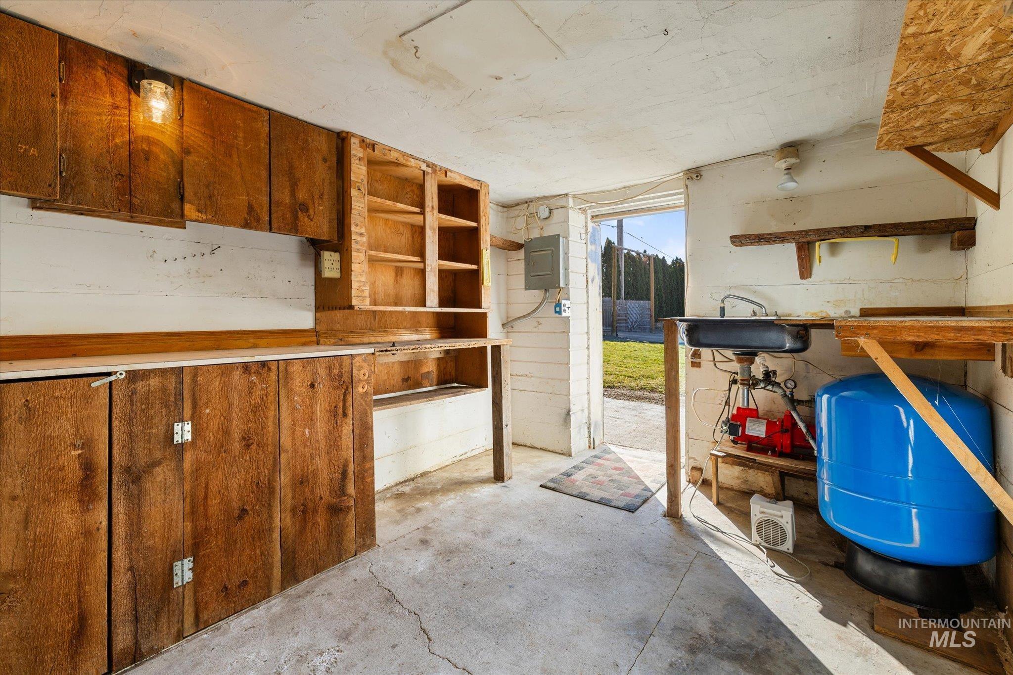 9820 Highway 44 Middleton, ID 83644 - Photo 47 of 50 Kitchen featuring concrete floors, electric panel, wood finish cabinets, and open shelves
