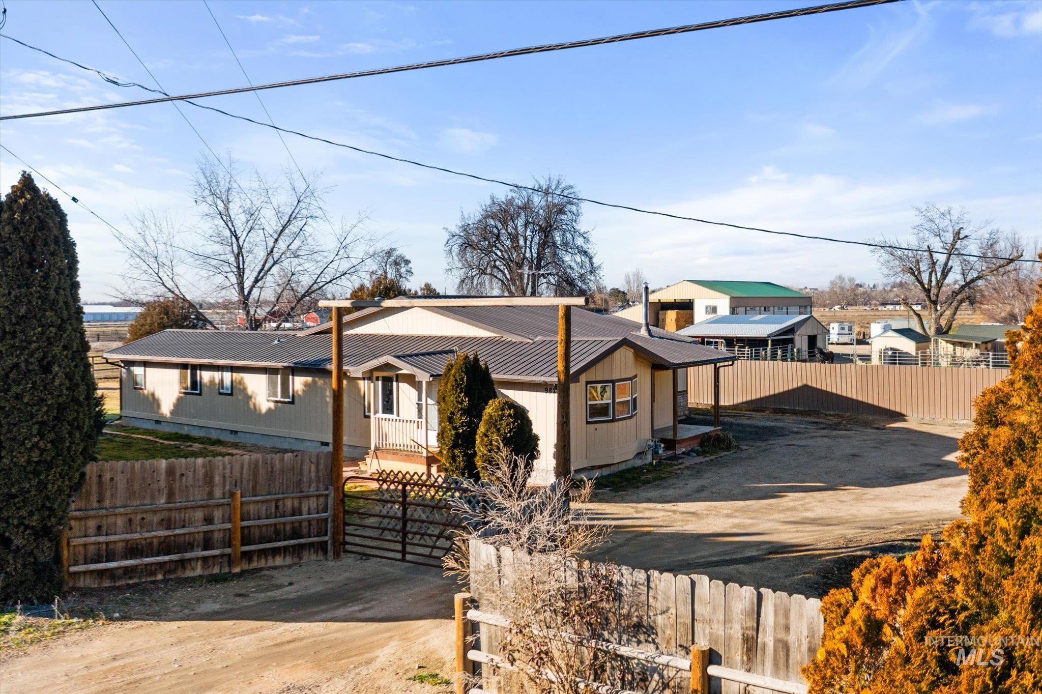9820 Highway 44 Middleton, ID 83644 - Photo 10 of 50 View of front of house featuring a fenced front yard, a metal roof, and dirt driveway
