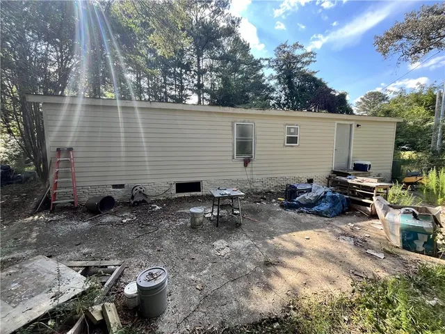 a view of a backyard with chairs and a patio