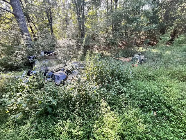 a view of chair and table in patio with wooden fence