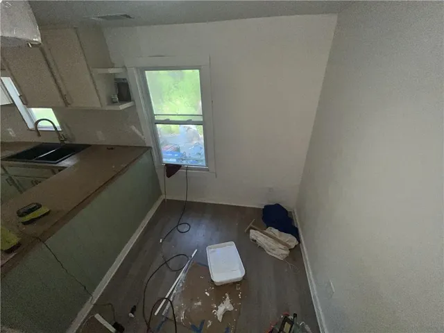 a kitchen with a sink appliances and cabinets