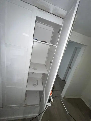 a view of a kitchen with wooden floor and a sink
