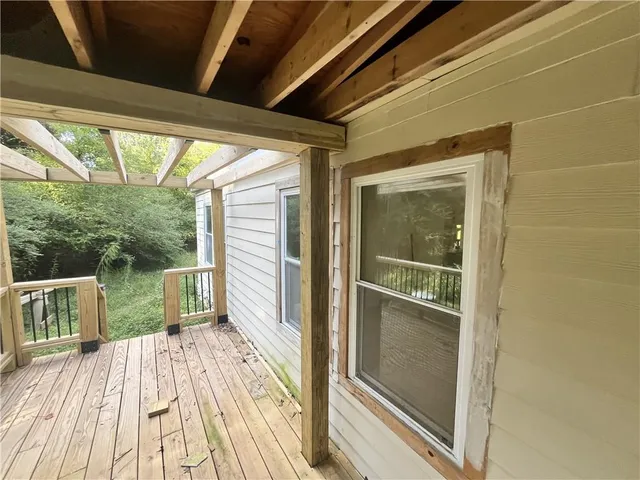 a porch with seating space and hardwood floor