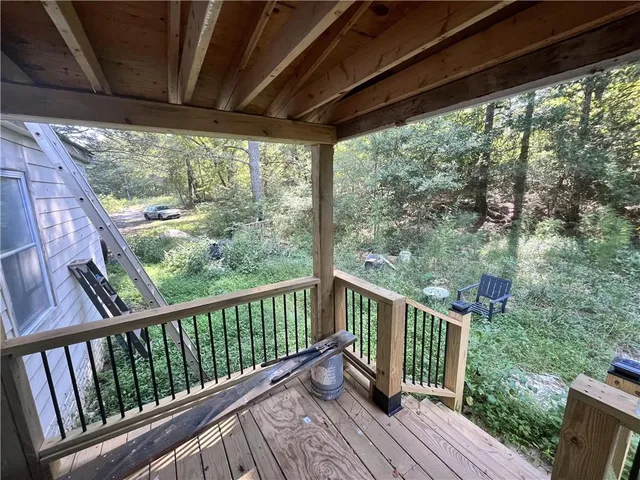 a view of a balcony with wooden floor