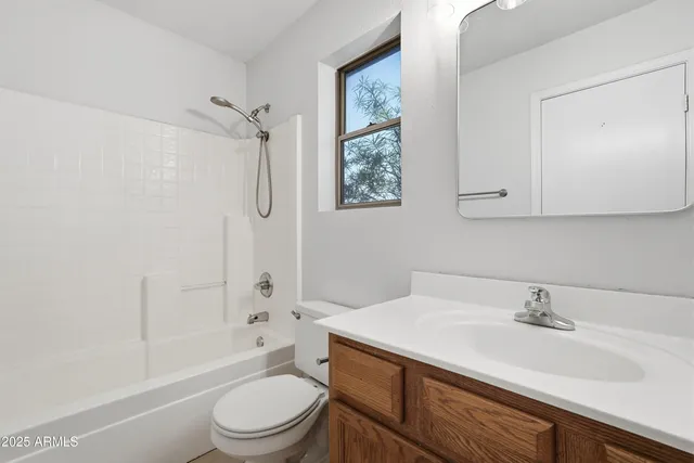 a bathroom with a sink toilet vanity and shower