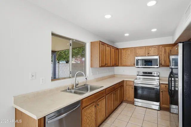 a kitchen with a sink stove and microwave