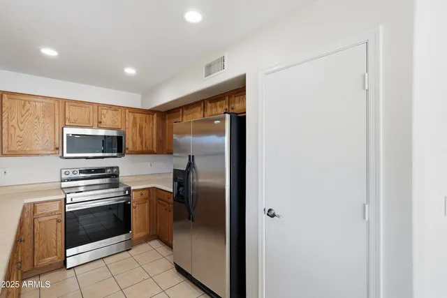 a kitchen with stainless steel appliances a refrigerator stove and microwave