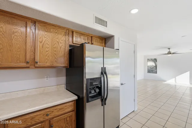 a kitchen with a refrigerator and cabinets