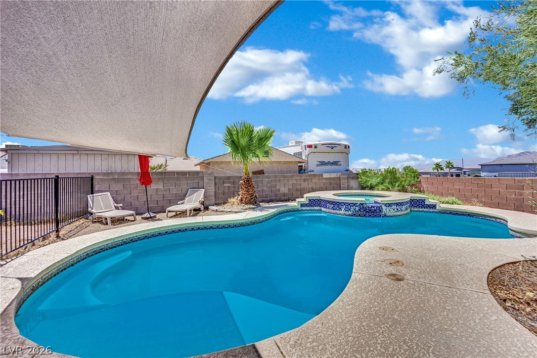 420 North Racetrack Road Henderson, NV 89015 - Photo 44 of 52 An inviting backyard oasis offers a freeform pool and integrated spa, perfect for cooling off or relaxing.