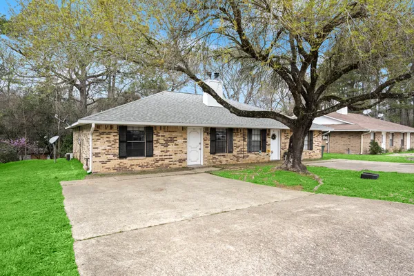 a front view of house with yard and green space