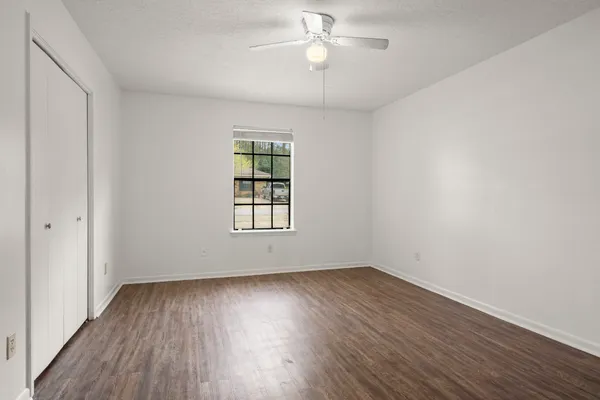 wooden floor in an empty room with a window