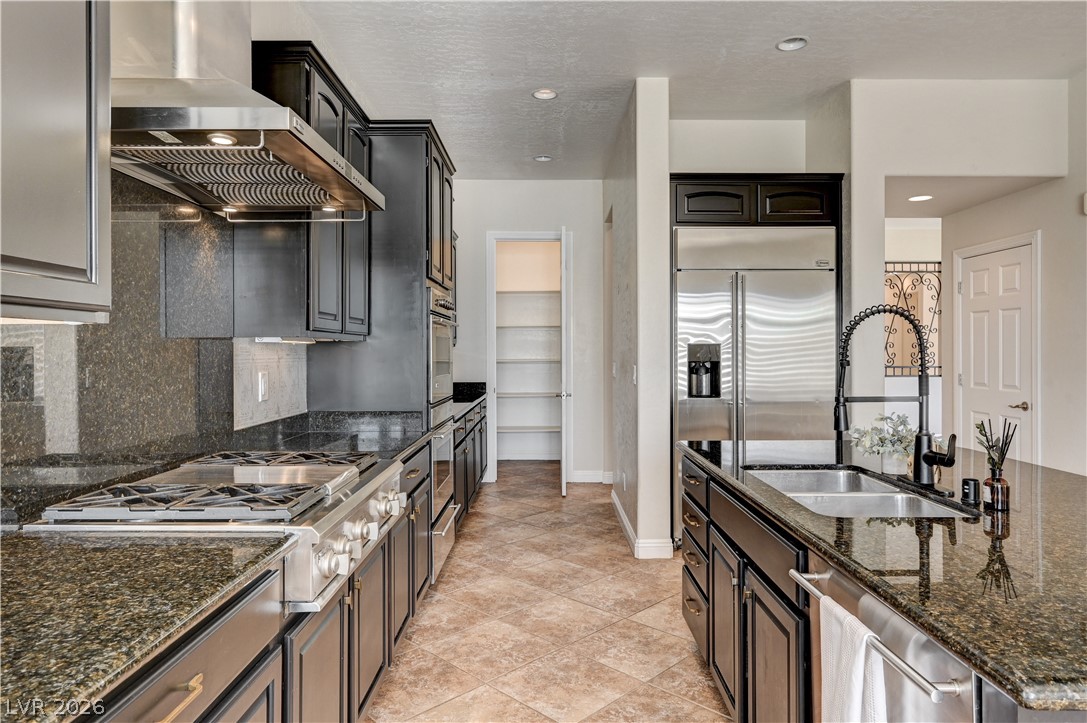2793 Rosenhearty Drive Henderson, NV 89044 - Photo 6 of 85 Culinary aspirations meet sophisticated design in this well-appointed kitchen featuring high-end appliances and ample counter space.