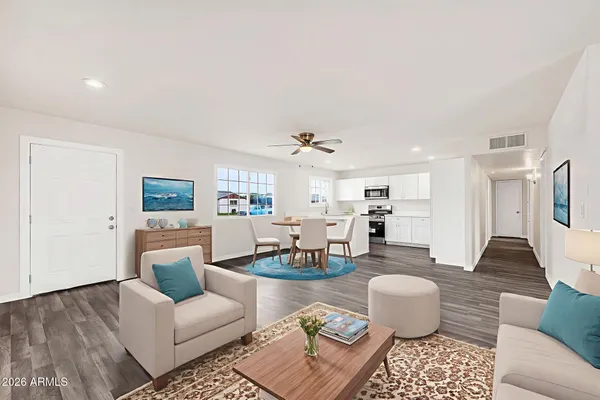 a living room with furniture and wooden floor
