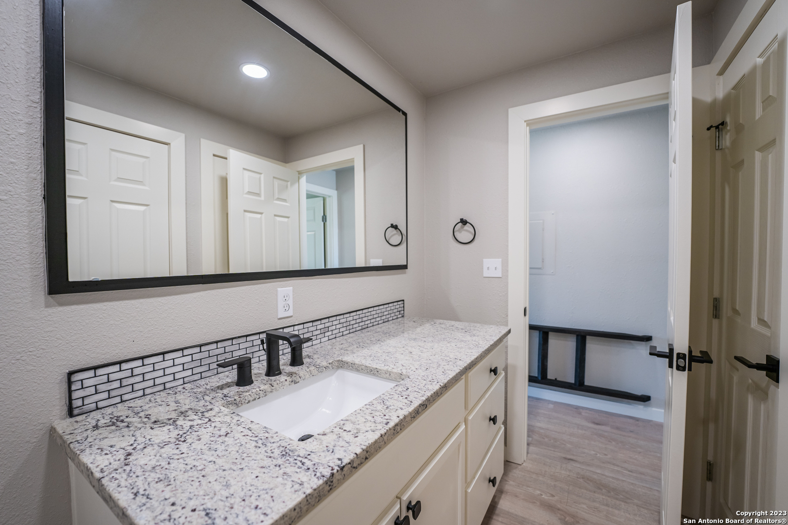 1225 Texas Oaks, Unit D Spring Branch, TX 78070 - Photo 11 of 20 a bathroom with a granite countertop sink and a mirror