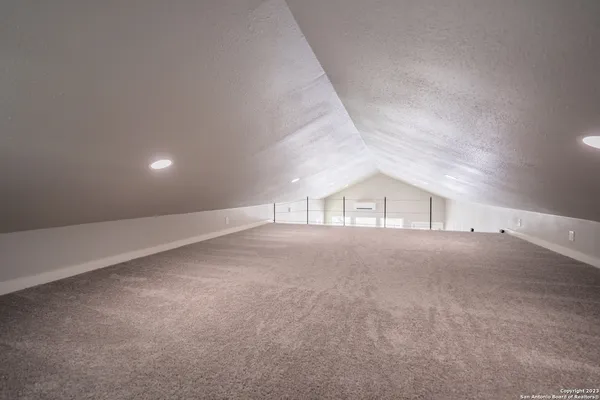 a front view of a house with a yard and lake view